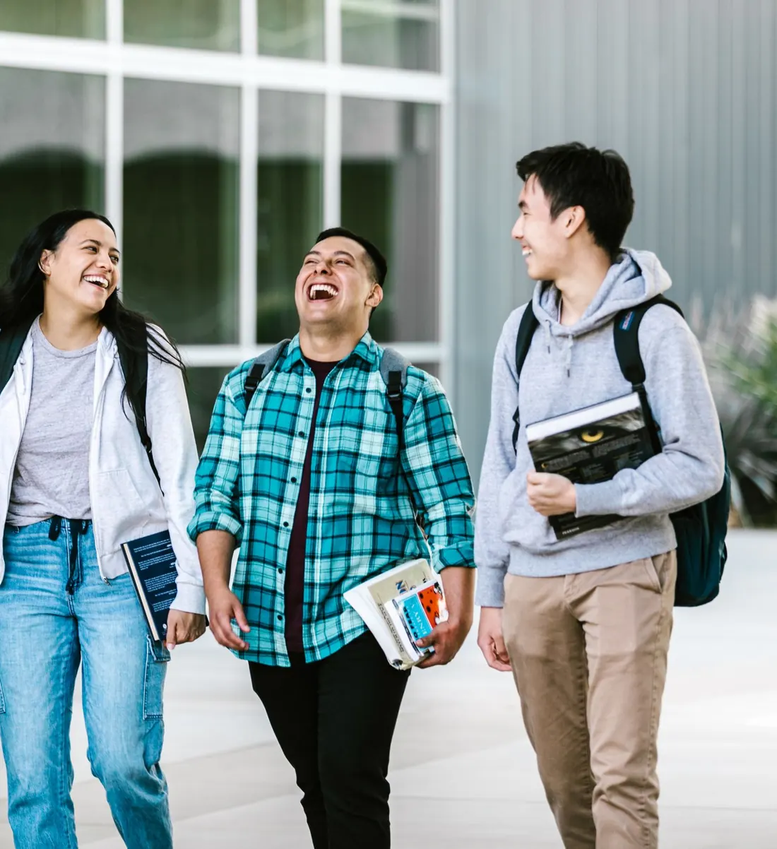 Students laughing together as they walk across campus